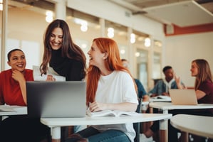 Instructor helping two adults students in an English class.